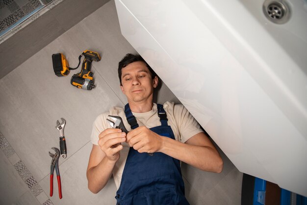 Male plumber working to fix problems at client's house